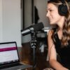 A woman laughs during a podcast