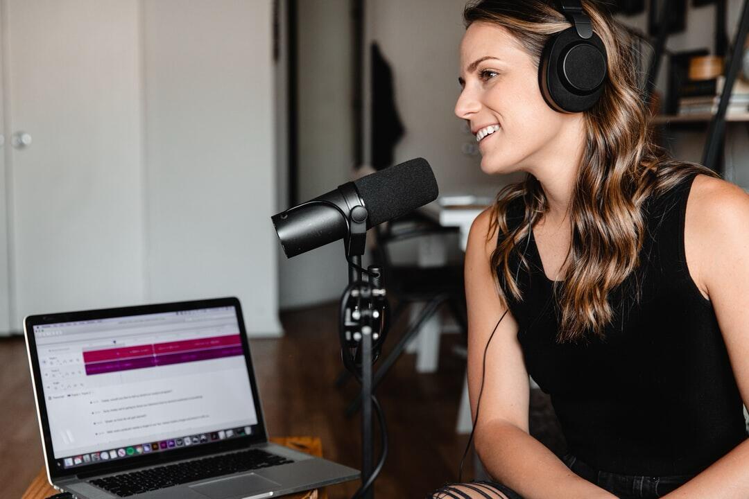 A woman laughs during a podcast