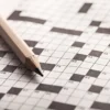 Crossword Puzzle and Pencil on background