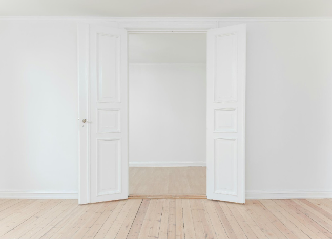 The white door of the house is open