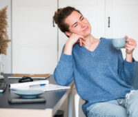 woman relaxing at desk in morning