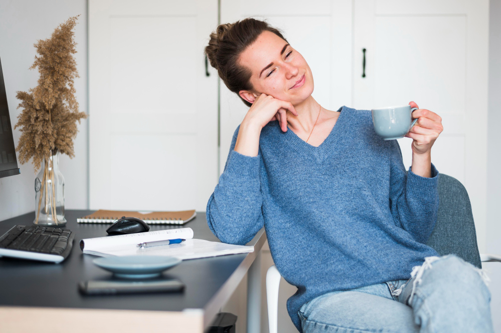 woman relaxing at desk in morning