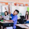 Students with Raised Hands in Classroom