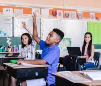 Students with Raised Hands in Classroom
