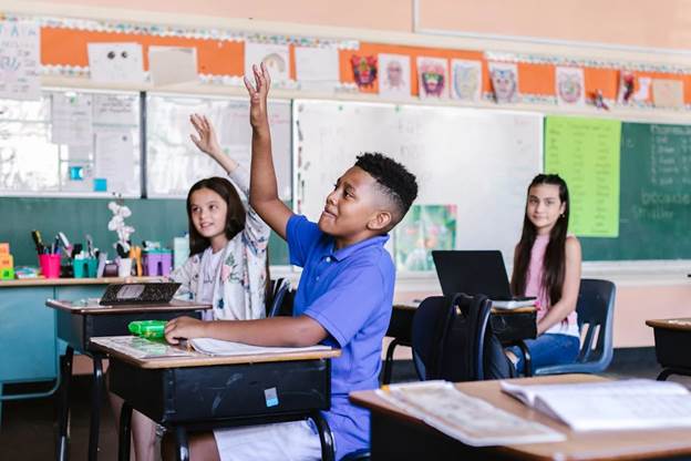 Students with Raised Hands in Classroom