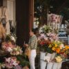A lady is standing in-front of a shop