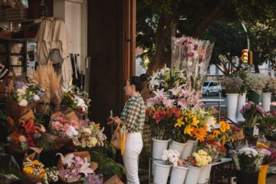 A lady is standing in-front of a shop