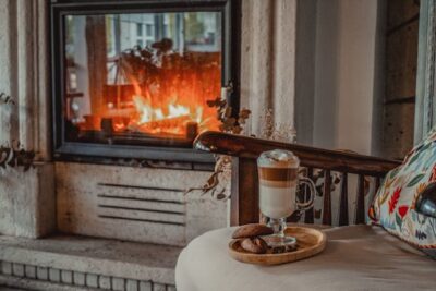 Coffee with Cream on Furniture Against Fireplace
