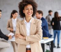 young smiling mixed race businesswoman standing in boardroom