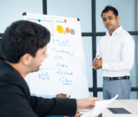 business trainer listening to audience questions after presentatioN