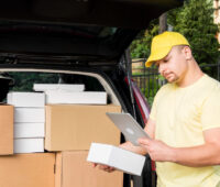 Delivery man holding tablet