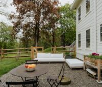 a patio with a table and chairs and a couch