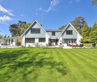 White and Gray Wooden House Near Grass Field and Trees