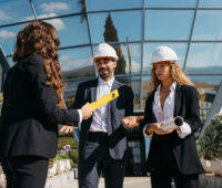 architects talking in front of glass buidling