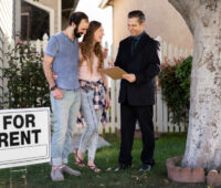 Couple signing papers for new house