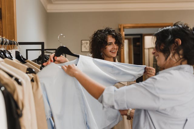 Woman Holding Clothes with Black Hanger