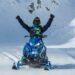 Man Riding Blue SnowMobile