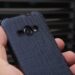 A person is holding a smartphone with a cover
