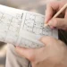 Man enjoying a sudoku game on paper