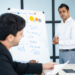 business trainer listening to audience questions after presentatioN