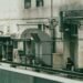A person sits amidst industrial machinery outdoors
